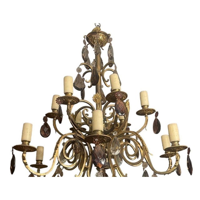 An elegant and richly detailed French early 20th century chandelier, crafted in brass and bronze and lavishly adorned with...