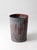 Early 20th century utility can featuring layers of weathered red paint over galvanized steel, creating a richly textured...