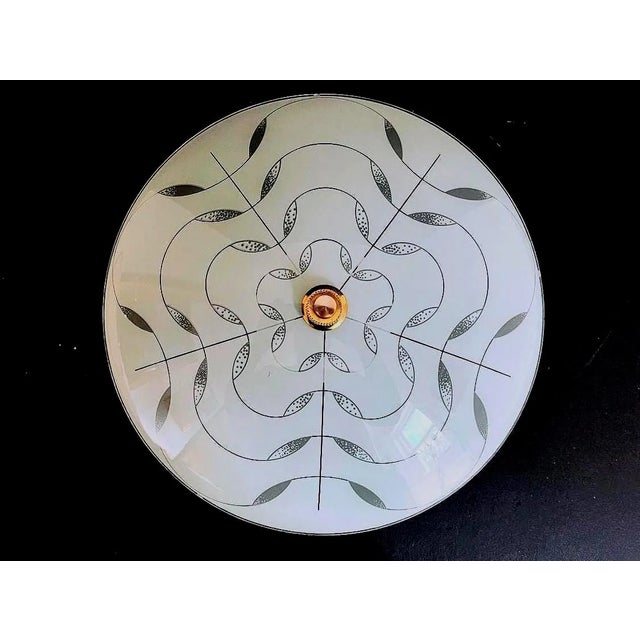 Fabulous modern domed and frosted glass flush mount light with a concentric ringed floral design accented by radiant...