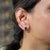A matched pair of AAA-grade tanzanites glows in a rich violet-blue in these solid 14K gold emerald cut solitaire stud...
