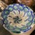 A beautiful Spanish Tin Glazed bowl from mid-20th century. The saturation of the blue and green ceramic glaze on a cream...