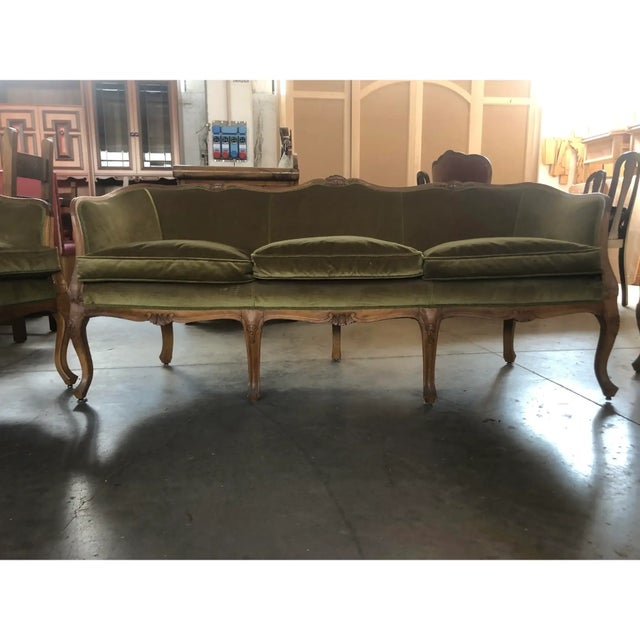 700 style set of two armchairs and a sofa in walnut wood carved by hand.Upholstered in goose down ricestiti in green silk...