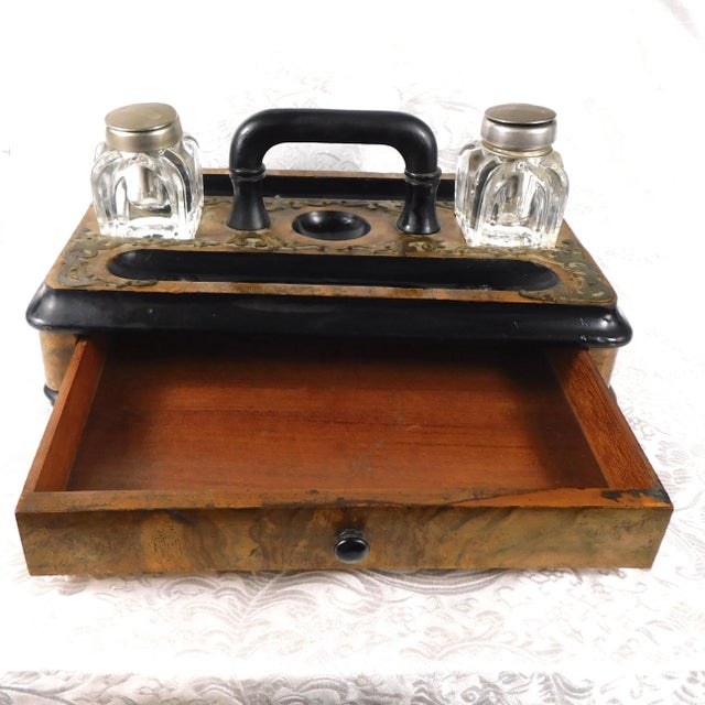 This is a wooden desk organizer that has two crystal inkwells with caps that may not be attached (I do not understand...