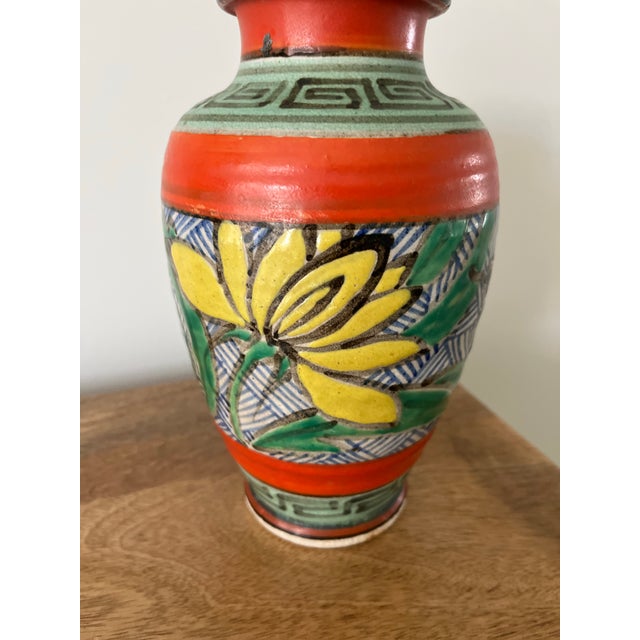 A gorgeous mid-century piece featuring the hand-painted, vibrant colors and geometric patterns often associated with...