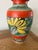 A gorgeous mid-century piece featuring the hand-painted, vibrant colors and geometric patterns often associated with...