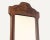 Vintage wall mirror with a carved wood frame featuring floral and leaf motifs at top and bottom. Scalloped silhouette with...