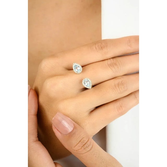 Elegant Blue Topaz & Diamond Open Ring in 14K White Gold Add a touch of timeless elegance to your jewelry collection with...