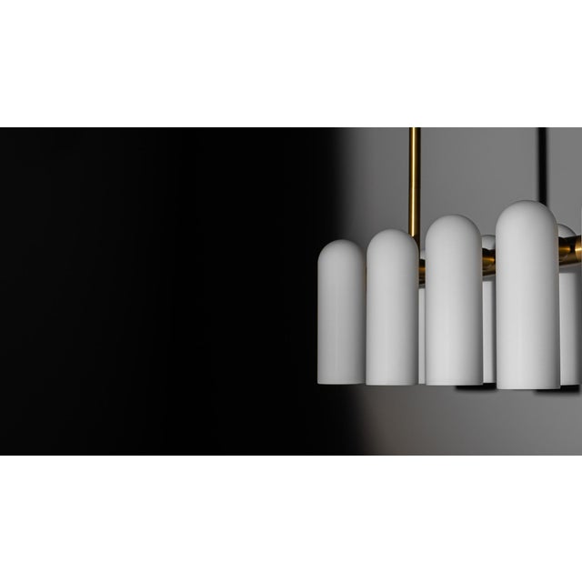 A colonnade of light sources. This delicate engine of frosted glass generates a luminous environment while contrasting...