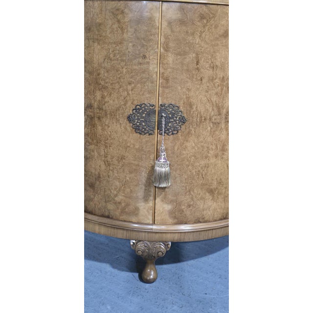 A superb quality two door burr walnut demi loon cabinet of narrow proportions, brass escutions and working key, two...