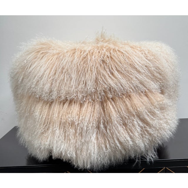 Blush colored Tibetan lamb ottoman with 4 wooden legs