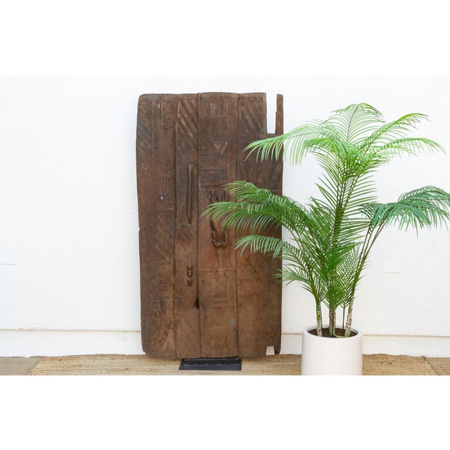 From the Nupe people of central Nigeria's Niger River region, this door is built from five narrow vertical planks, each...