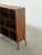 W48 D13 H44.5 Shelf H11 This vintage low-profile bookshelf features an asymmetrical cubby configuration and an elegant,...