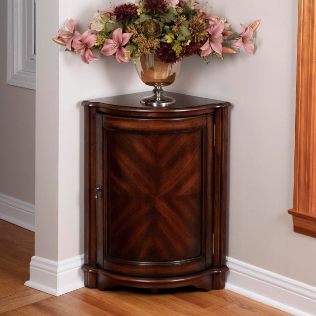 Perfect for dressing up a neglected corner. This cabinet features cherry veneers along its top and door panel. The door,...