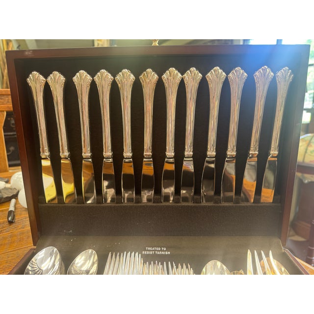 Beautiful service for 12 in great condition. Has been used one time. Includes 4 serving pieces. In original wooden chest...
