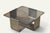 A 1970s coffee table inspired by François Monnet, combining a sculptural brushed steel base with a smoked glass top...