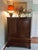 A handsome George II–style dwarf linen chest, crafted in a warm cherry finish with clean paneled doors and classic brass...