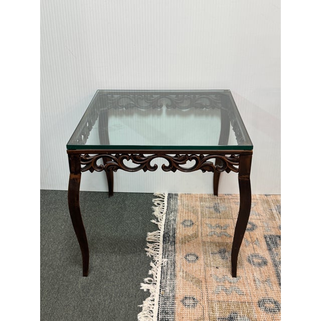 Design Plus Gallery presents a Metal Side Table from the Mid 20th Century. The table has a wrought iron frame with curved...