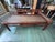 An antique Chinese provincial daybed from the late Qing dynasty, about 1880–1920, in elm with its original red-brown...