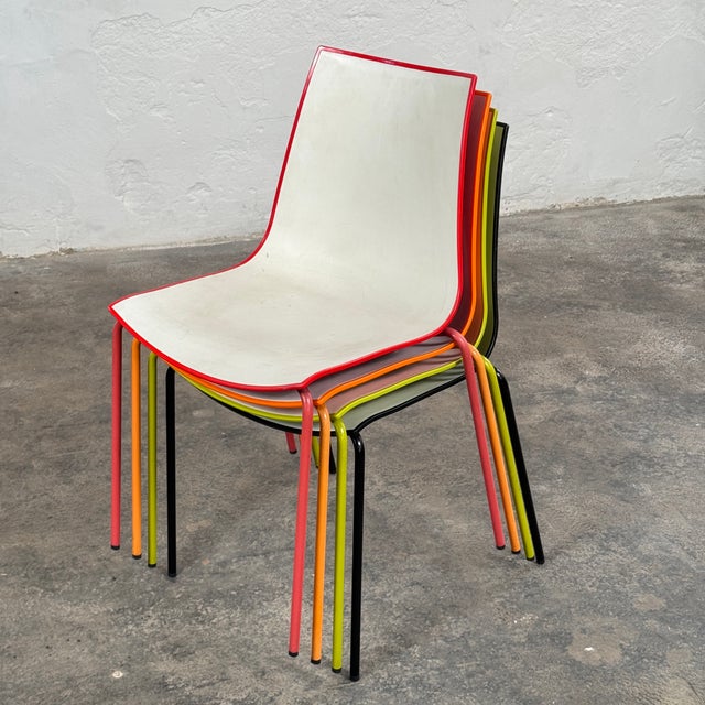 This set of four dining chairs is a vibrant example of contemporary italian industrial design from pedrali. The 3d colour...