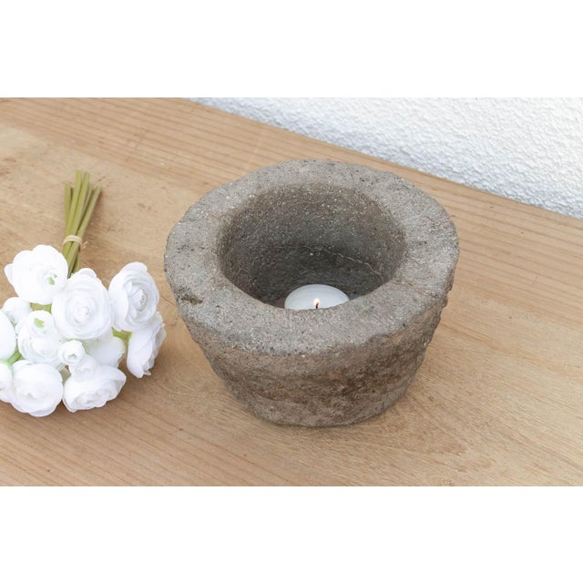 This heavy stone mortar is a relic of the "Old World" kitchen. Carved from a single block of solid granite, it was...