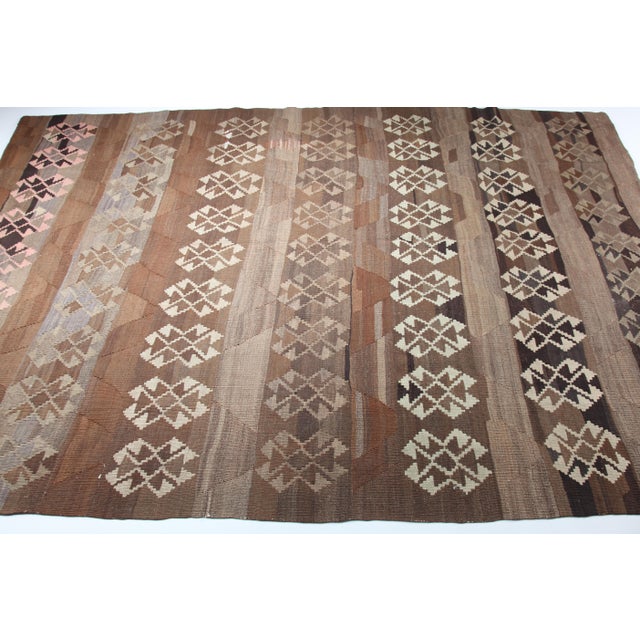Vintage Anatolian Flatweave Kilim in Earthy Brown Tones This authentic vintage flatweave kilim showcases a harmonious...
