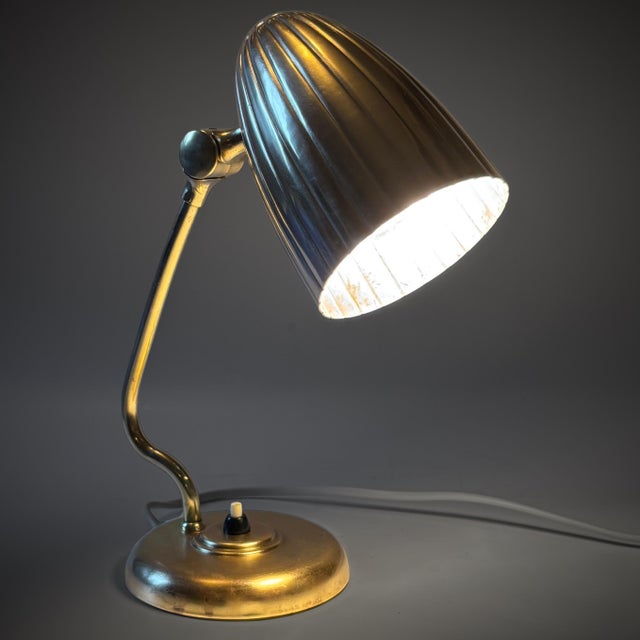 A beautiful table lamp, model 15479, designed in the 1940s by Harald Notini for the renowned Swedish manufacturer Arvid...