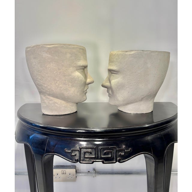 A striking pair of contemporary cement face pots, blending modern minimalism with a touch of sculptural whimsy. Crafted in...