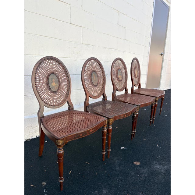 A refined set of four Neoclassical antique chairs featuring beautifully hand-painted portrait medallions and floral...