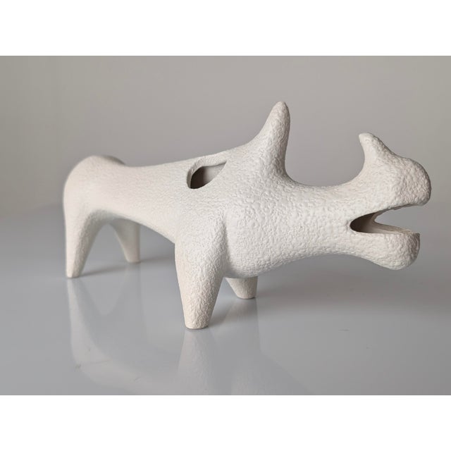 This sculpture depicts a stylized rhinoceros, designed by Roberto Rigon in Italy during the 1970s. The piece is made of...