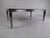 This stunning vintage modern coffee table boasts a stainless steel base with unique legs that graduate downward. A smoked...