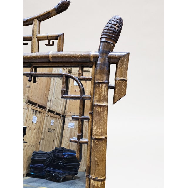 With rectangular mirror plate within a conforming natural bamboo surround with the upper corners overlaid with bamboo...