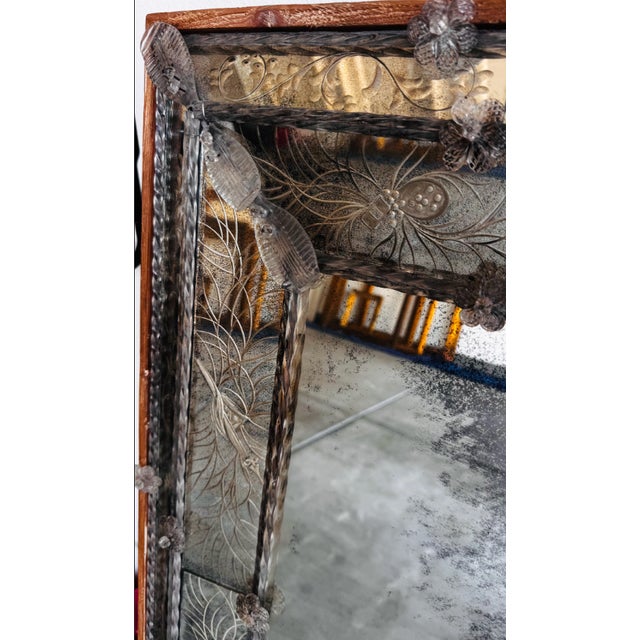 Custom made Venetian mirror, hand carving in Murano glass surrounded by wood. Antiqued silver glass.