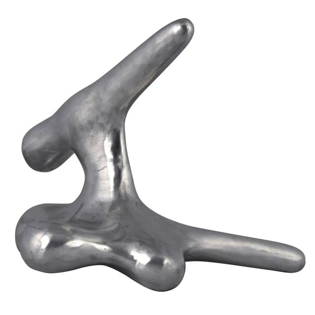 This metal alloy sculpture is a bold way to add interest to any decor. Small idiosyncrasies due to the artisan crafted...