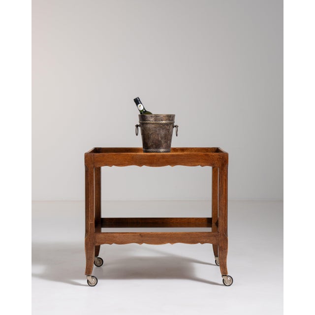 A practical and elegant oak bar cart designed for mobility and ease of use. The compact structure and tiered surfaces...