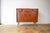 This is a beautifully designed teak dresser from the 1960s. The cabinet features two drawers and a larger storage space...