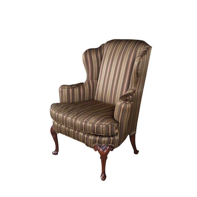 A stately wingback chair by Baker Furniture, circa 1980s. Features a flared open stance upholstered in a beautiful silk...