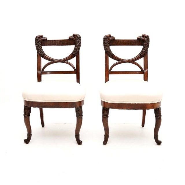 A fantastic pair of antique carved side chairs. They were made in continental Europe, possibly Denmark, or somewhere close...