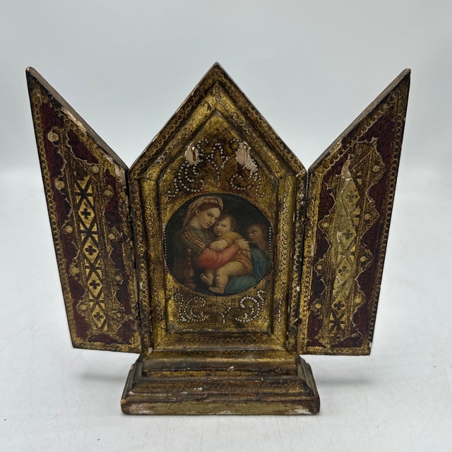 This is a small antique religious devotional shrine (a triptych). It’s a tabletop piece made of wood and gesso with worn...