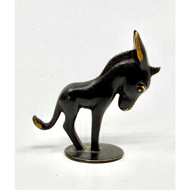 A lovely little bronze figurine of a donkey y Richard Rohac of Austria. It is stamped on the base. The piece is in good...
