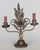 A pair of rustic cast iron and patinated metal two-light candelabra with flower leaves and scroll forms. Original candle...