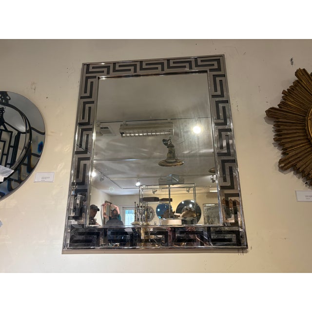 Greek Key Chrome Mirror. Offered is a great Post-Modern rectangular chorme mirror with a Greek key perimeter. This...