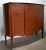 This rosewood and cottonwood bar cabinet was manufactured in the 1950s. This piece has an attribution mark, I am sure that...