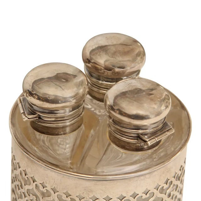 This Antique French Sterling Silver and Glass Scent Bottle Caddy exudes timeless elegance and craftsmanship. Featuring...