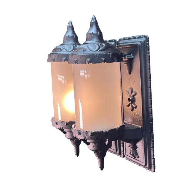 Pair 1910s or 1920s exterior sconces with cylinder shades. New black paint and new glass. Top of lamp flips up to access...