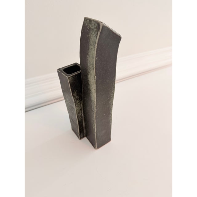 Handcrafted sculptural studio pottery double bud vase featuring an architectural twin-column form with two asymmetrical...