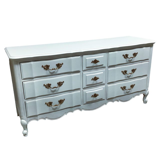 Lovey solid wood vintage triple dresser with 9 drawers, 3 larger one on each side with smaller center drawers. We painted...