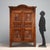 Double-piece walnut wardrobe. Tripartite doors with carved panels and ribbed moldings, a cymatium with carved rosettes...