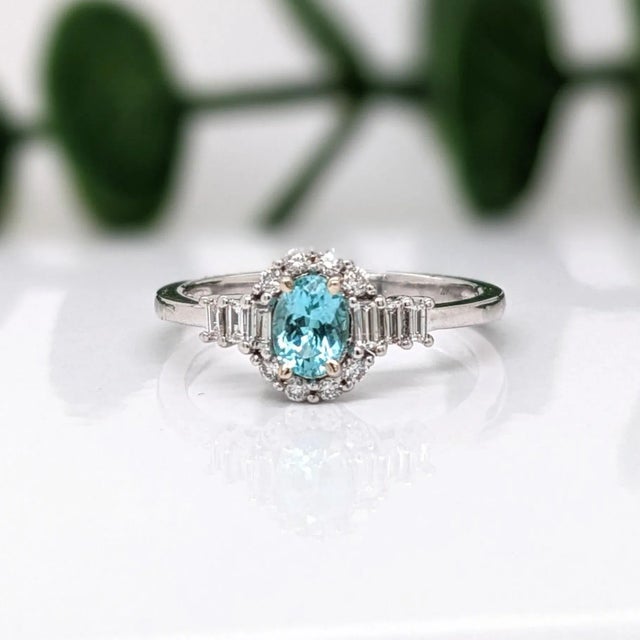 This gorgeous blue Afghan tourmaline ring is showcased in a custom NNJ ring design with two sizes of natural diamond...