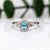 This gorgeous blue Afghan tourmaline ring is showcased in a custom NNJ ring design with two sizes of natural diamond...