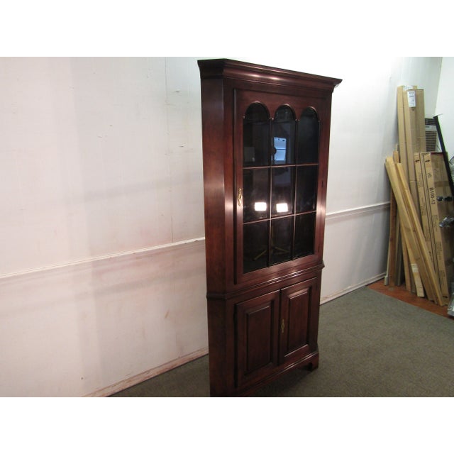 Item 83479: Statton solid Cherry corner china cabinet. Age: 1980's. Details: Lighted interior and Old Towne finish....